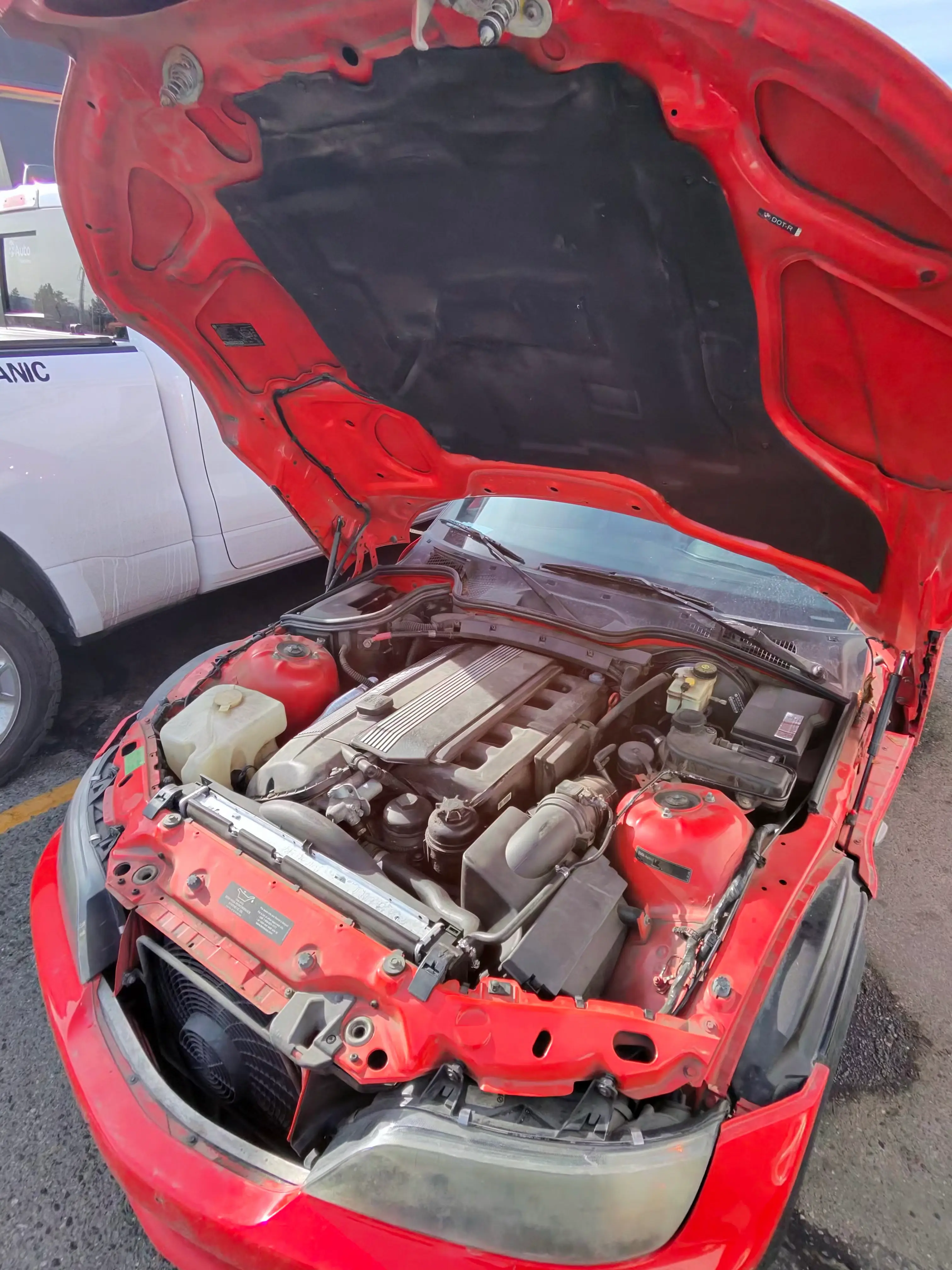 BMW Z3 engine bay open during on-site diagnostic