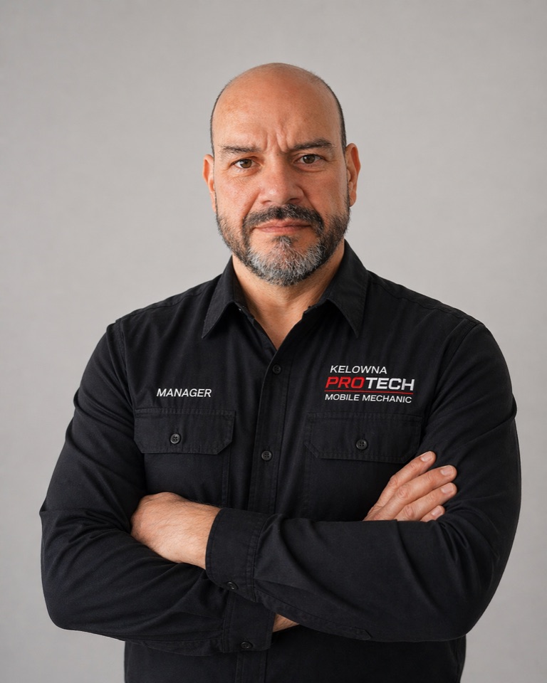 Joseph, Lead Mechanic and Service Manager at Kelowna Protech Elite Mobile Mechanic, wearing a branded Kelowna Protech uniform