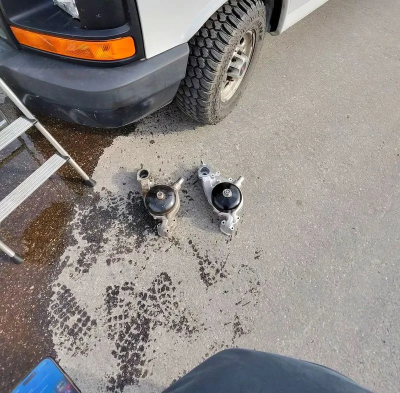 Failed water pump removed from a 2016 GMC Savana, confirming the coolant leak source on-site in Kelowna