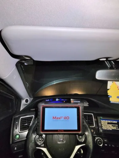 Autel MaxiPRO diagnostic scanner mounted on the steering wheel reading a Honda Civic's ABS system fault